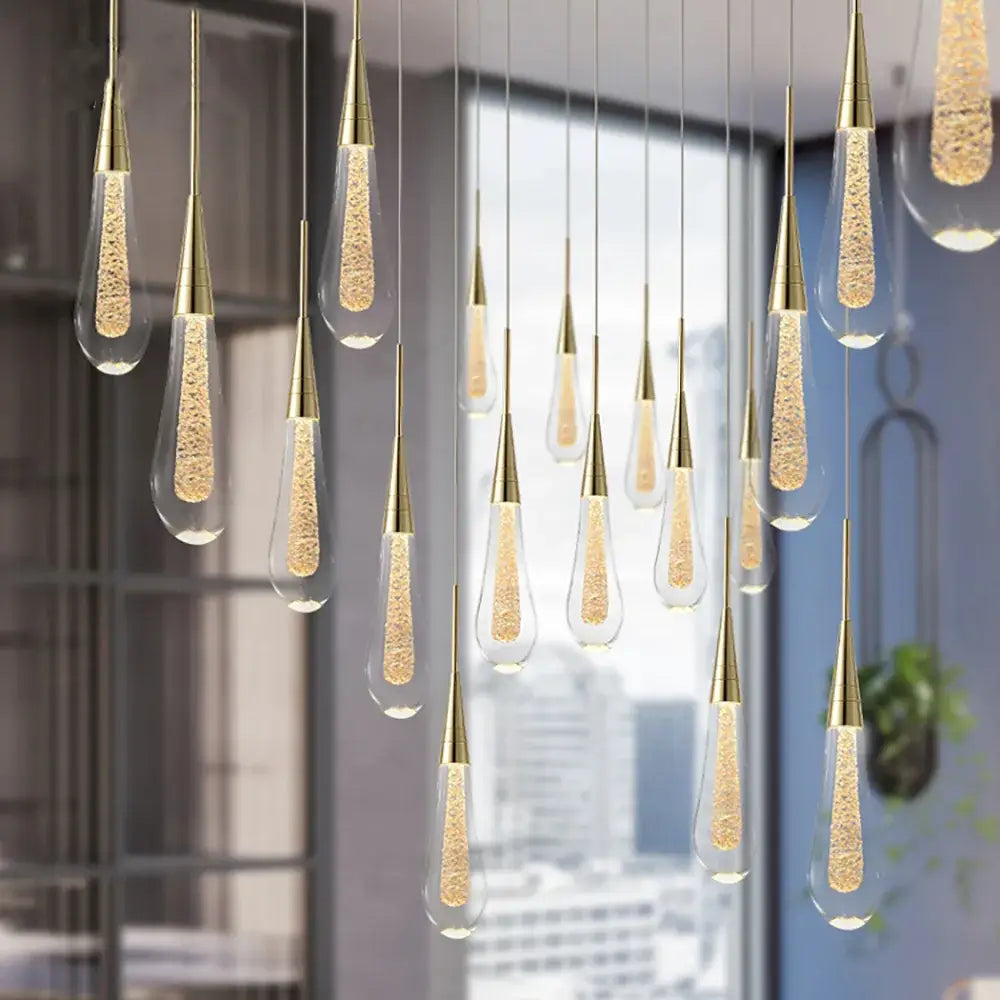 Modern gold pendant lights with clear teardrop decorbites crystal glass shades filled with glowing golden beads