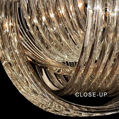 A modern gold crystal glass pendant lights dining room chandelier with intricate twisted glass arms reflecting light