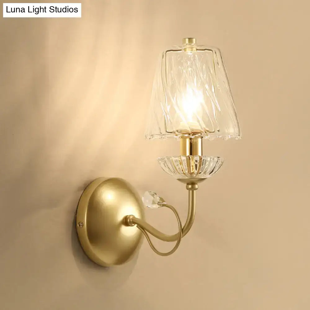 Antique brass living room wall sconce with textured glass shade and crystal accents in modern gold finish