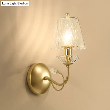 Antique brass living room wall sconce with textured glass shade and crystal accents in modern gold finish