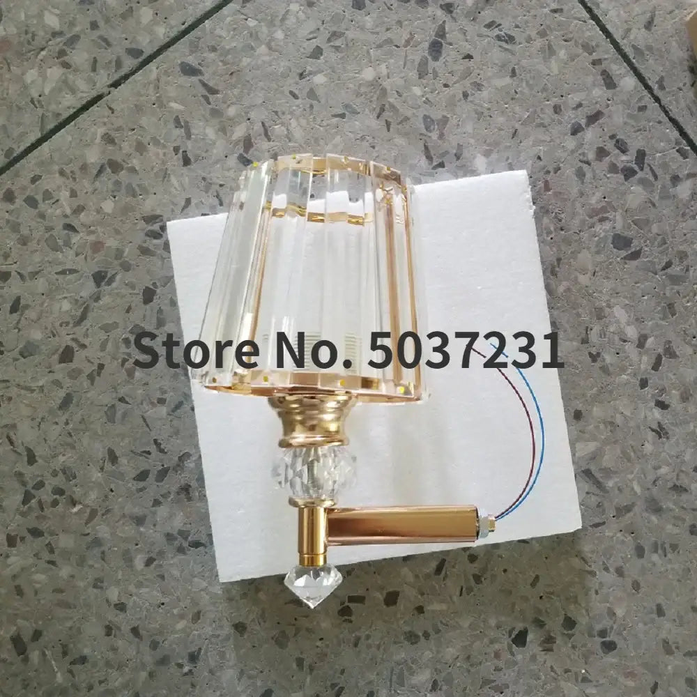 Modern gold crystal glass wall lamp with faceted clear glass shade and metal base for luxury bedroom decorbites crystal glass
