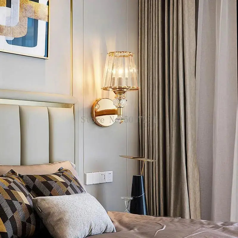Modern gold crystal glass wall lamp featuring a gold-toned sconce with faceted crystal shade and mirrored backplate