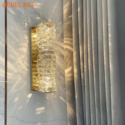 Modern gold crystal glass wall sconce with stacked faceted crystals emitting warm glow for bedroom decorbites crystal glass lighting