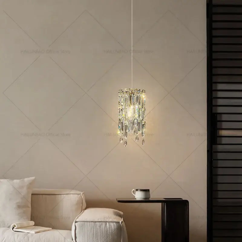 Modern gold crystal headboard chandelier with cascading clear prisms and warm glowing light by decorbites crystal headboard