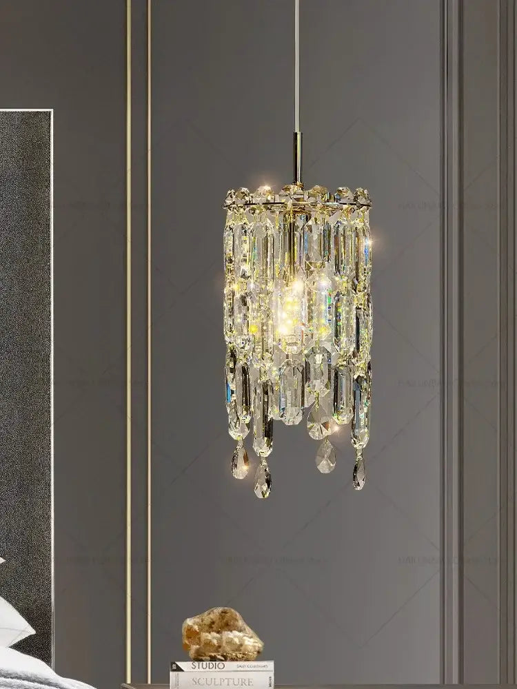 Modern gold crystal headboard chandelier with sparkling cascading faceted prisms by decorbites for master bedroom decor