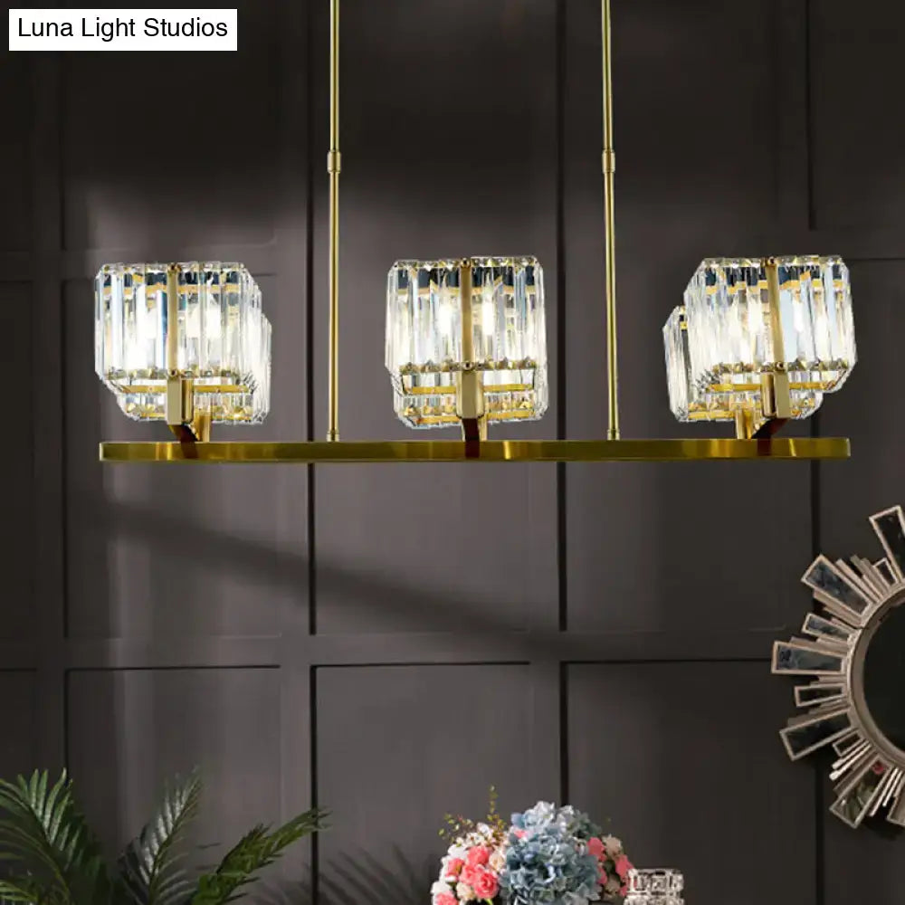 Modern gold crystal island light fixture with six heads and three rectangular shades suspended by slender rods