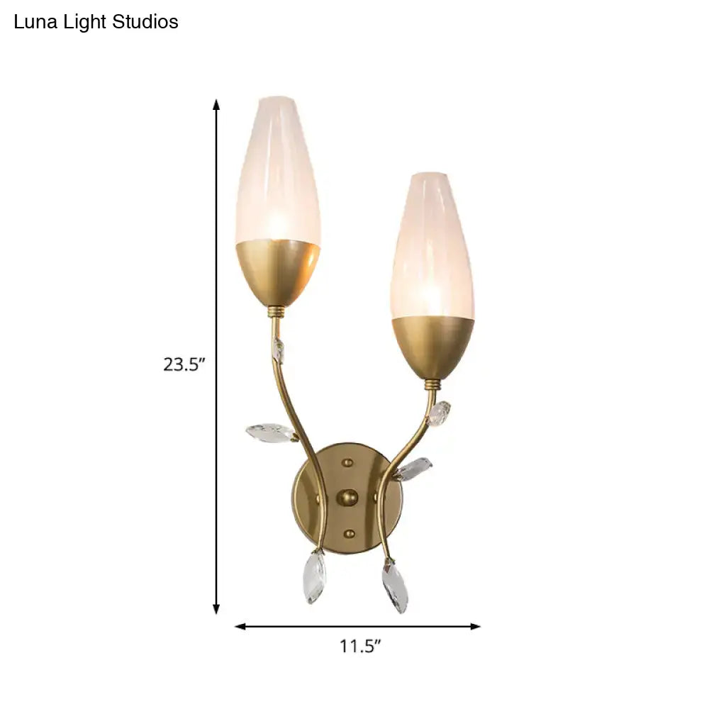 Modern gold crystal leaf wall sconce with brass finish, frosted glass shades, and crystal leaf design accents