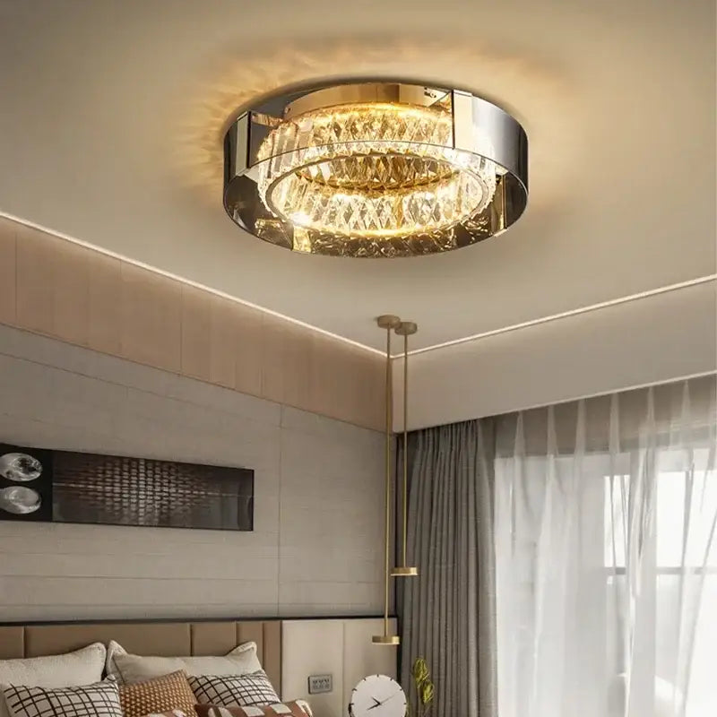 Modern gold crystal led ceiling chandelier with polished chrome frame and faceted crystal tiers emitting warm glow