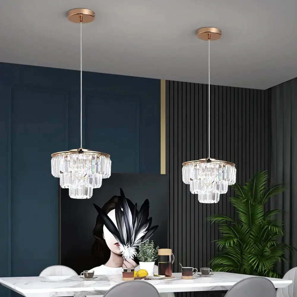 Two modern gold crystal led ceiling chandeliers with cascading clear glass crystals for dining room lighting