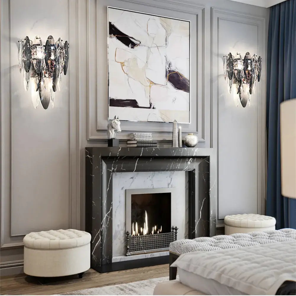 Black marble fireplace with silver firebox and mantel beneath modern gold decorbites crystal led ceiling chandelier