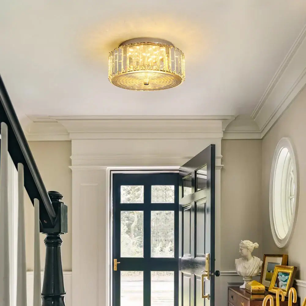 Modern gold crystal led ceiling light with metallic frame and cascading crystals emitting warm golden glow for dining room chandelier