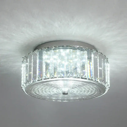 Modern gold crystal led ceiling chandelier with sleek chrome base and clear faceted glass prisms in concentric rings