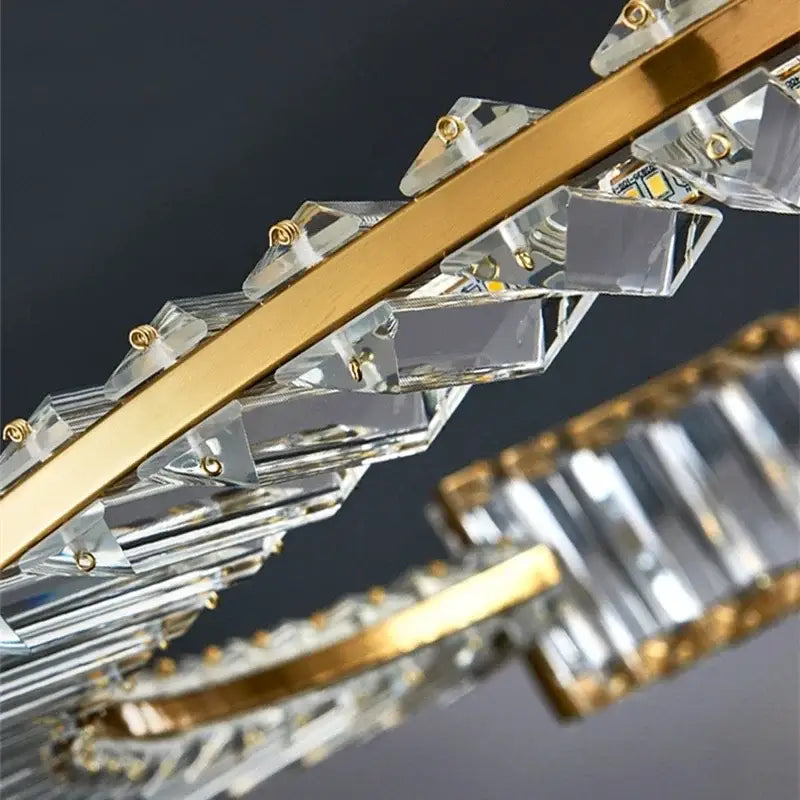 A modern gold crystal led chandelier with sleek metal frame and faceted prisms for elegant dining room decorbites crystal led