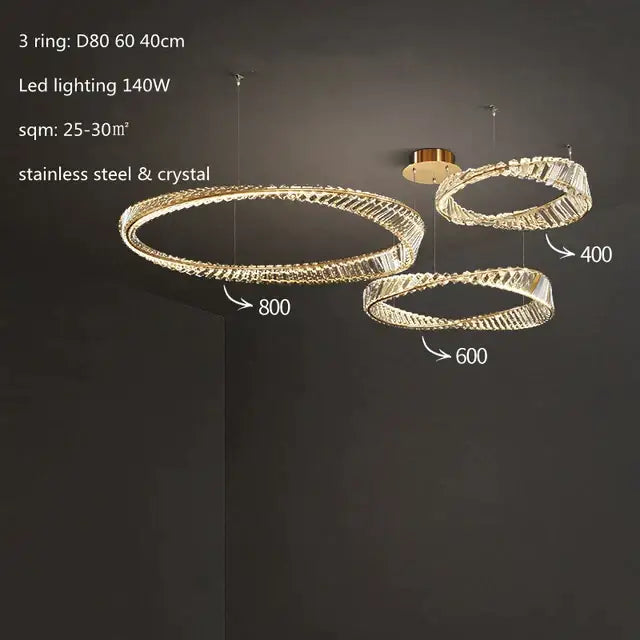 Modern gold crystal led chandelier featuring three interconnected stainless steel and crystal pendant lights by decorbites crystal led
