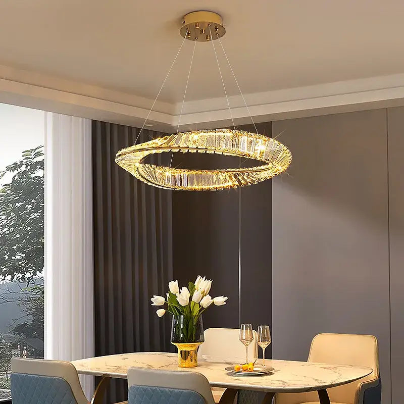 A modern gold-toned decorbites crystal led chandelier with double ring pendant and embedded crystals for dining room decor