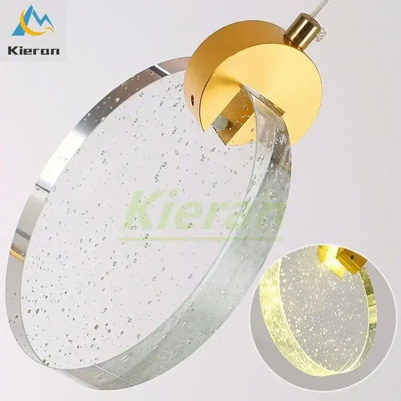 Modern gold crystal led chandelier featuring a gold-toned circular pendant light with bubble-filled glass and chrome trim