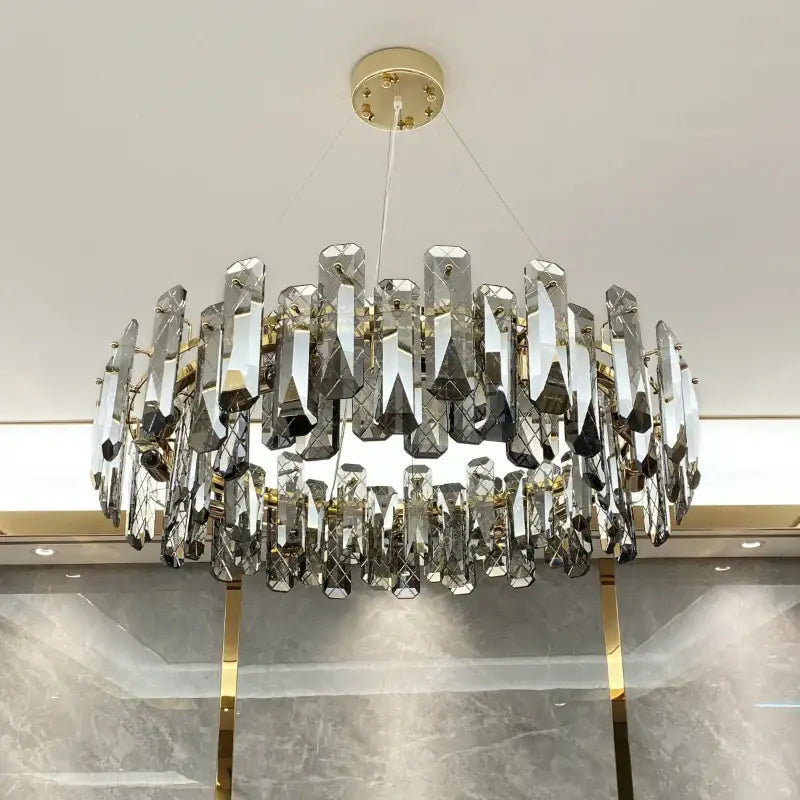Modern gold crystal led chandelier with faceted crystal prisms suspended from gold-toned mount by Decorbites crystal led