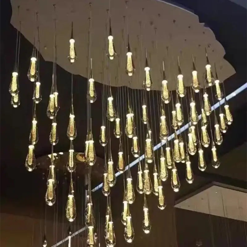 Modern gold crystal led chandelier with teardrop glass pendants from decorbites crystal led collection for dining room decor