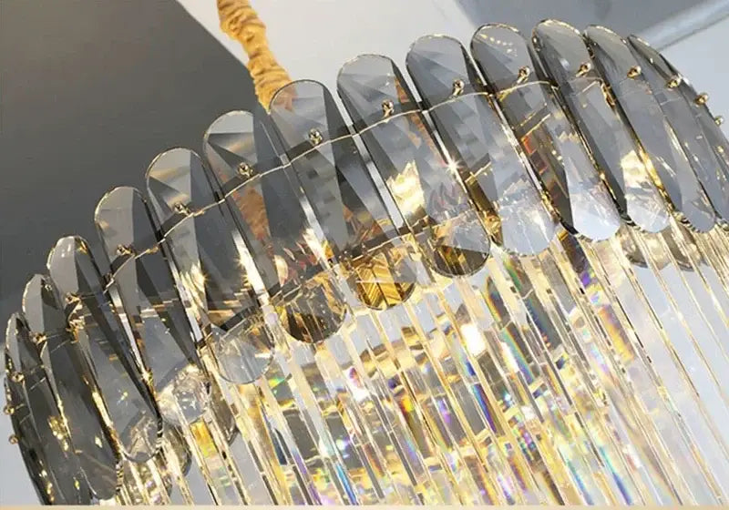Modern gold crystal led pendant chandelier featuring clear and dark gray crystal prisms by decorbites for dining room decor