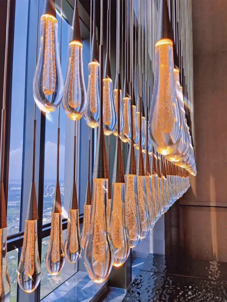 Modern gold crystal led pendant chandelier with teardrop glass pendants and internal lighting for living room decorbites crystal led