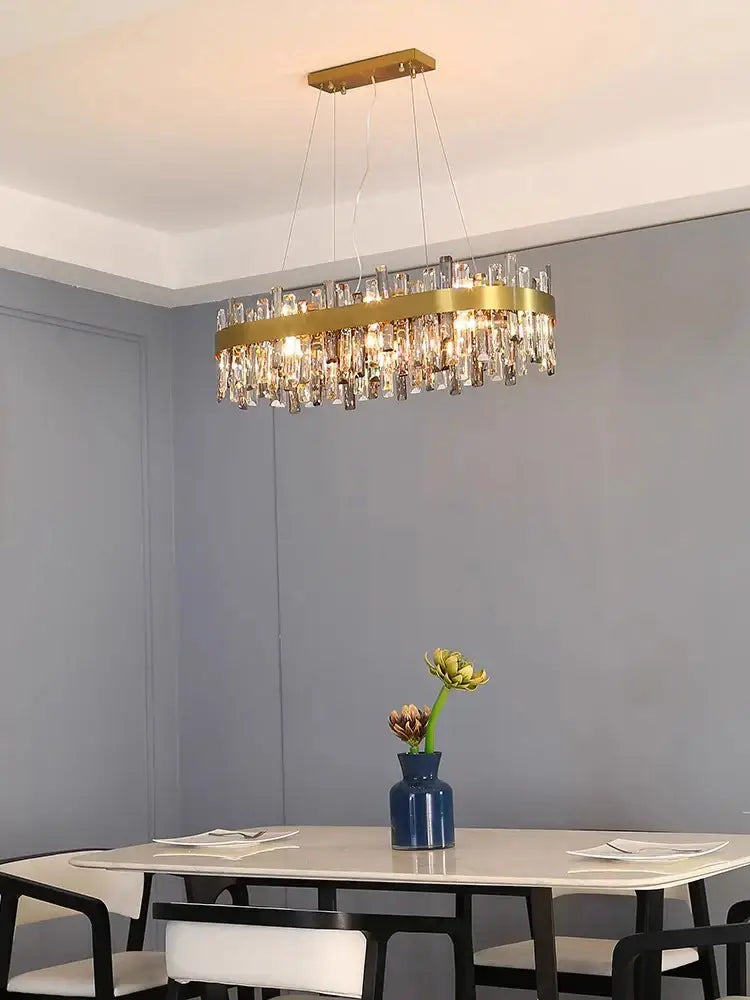 Modern gold crystal led pendant light with gold-toned rectangular frame and dangling crystal rods for dining room decorbites crystal led