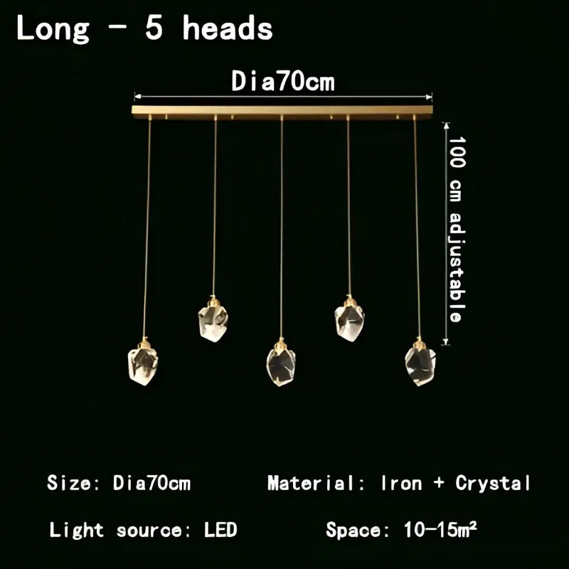 A modern gold crystal led pendant light featuring five faceted crystal pendants on a sleek brass bar for dining room