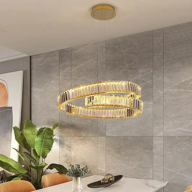 Modern gold crystal led pendant lights featuring a gold-toned double-ring chandelier with faceted crystal accents for dining room decorbites crystal led