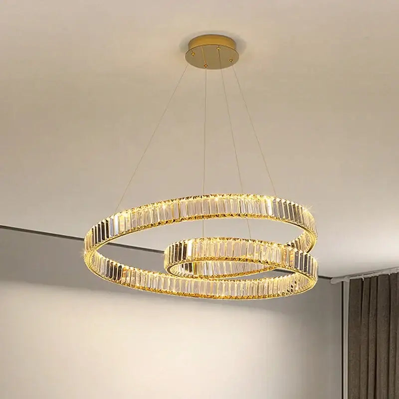 Modern gold crystal led pendant lights featuring a gold-toned double-ring chandelier with faceted crystal accents for dining room decorbites crystal led