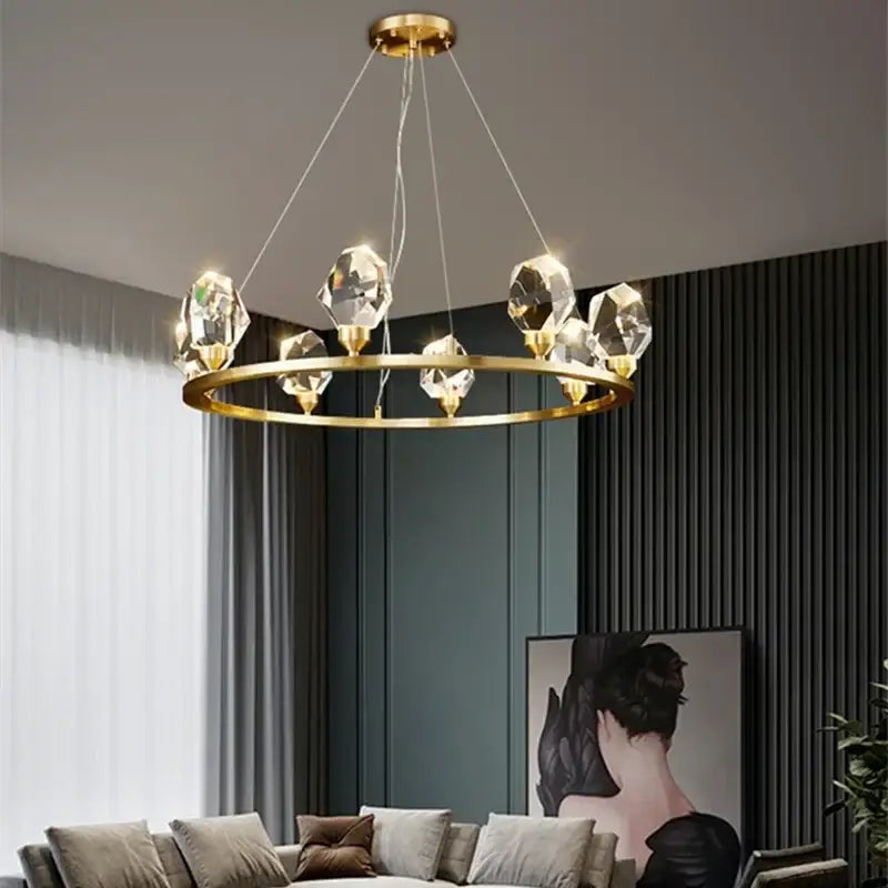 Modern gold crystal led pendant lights feature a gold-toned circular chandelier with faceted crystal pendants for dining room