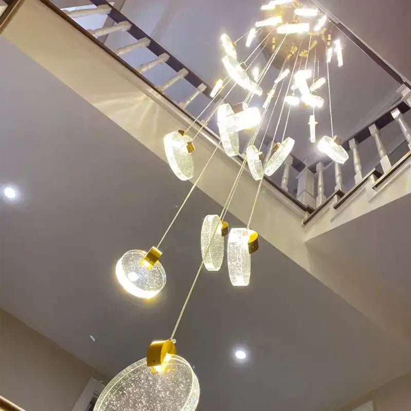 Modern gold crystal led stair slinglight pendant light with cascading circular glass orbs and gold-toned decorbites crystal led fixtures