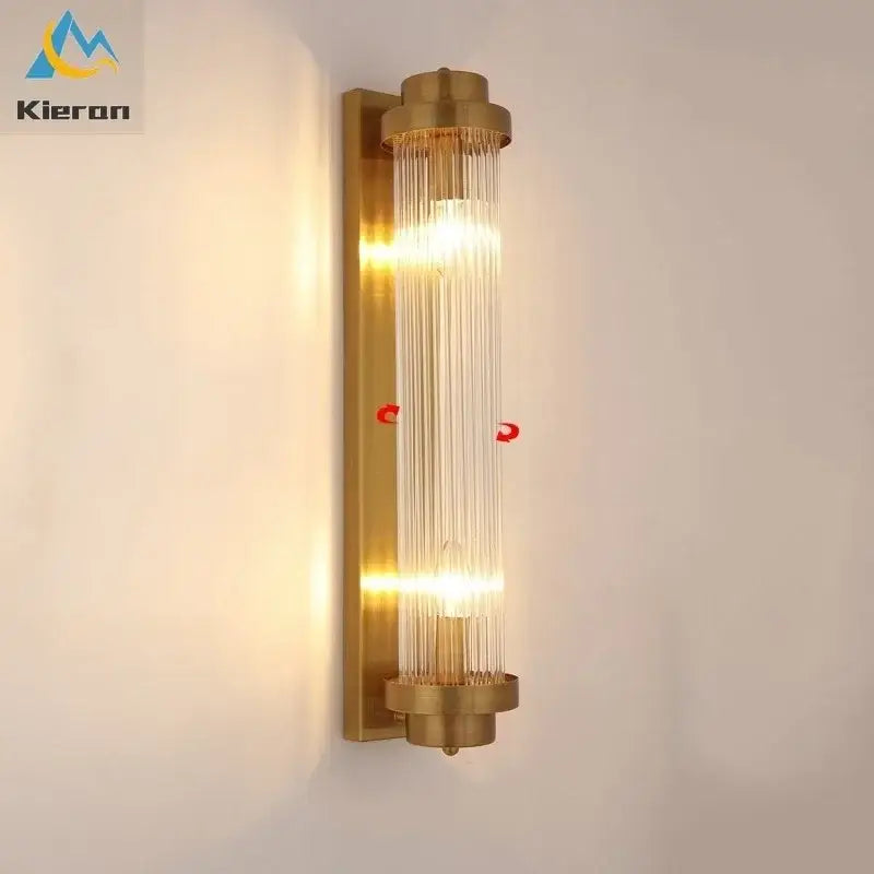 Brass-finished decorbites crystal led wall lamp with vertical glass rods and warm glowing light for modern bedroom decor