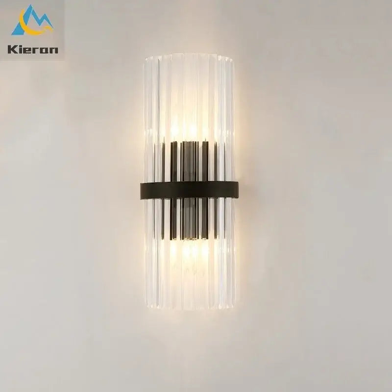 Modern gold crystal led wall lamp with clear glass cylinder, vertical ridges, and black metal band for stylish decorbites crystal led wall lighting