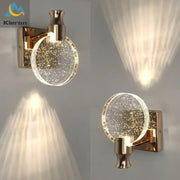 Modern gold-toned wall lamp with a crystal led glass globe filled with sparkling particles for elegant bedroom decorbites crystal led wall