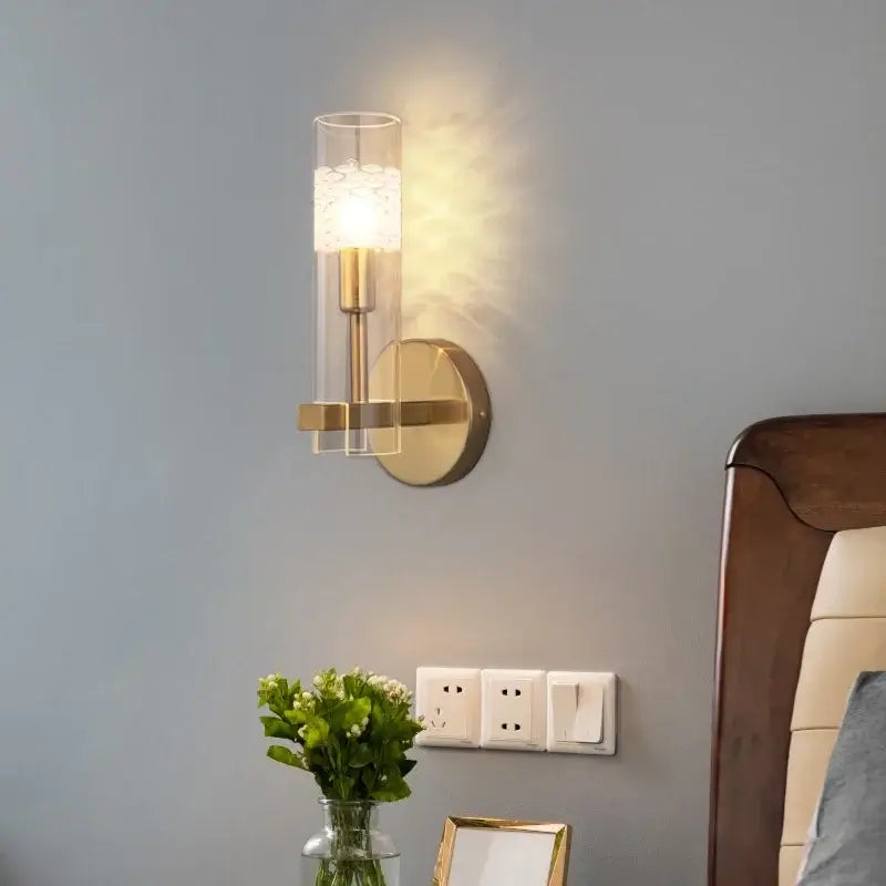 Modern gold crystal led wall lamp featuring a clear glass cylinder and illuminated textured white lampshade for decorbites crystal led wall lighting