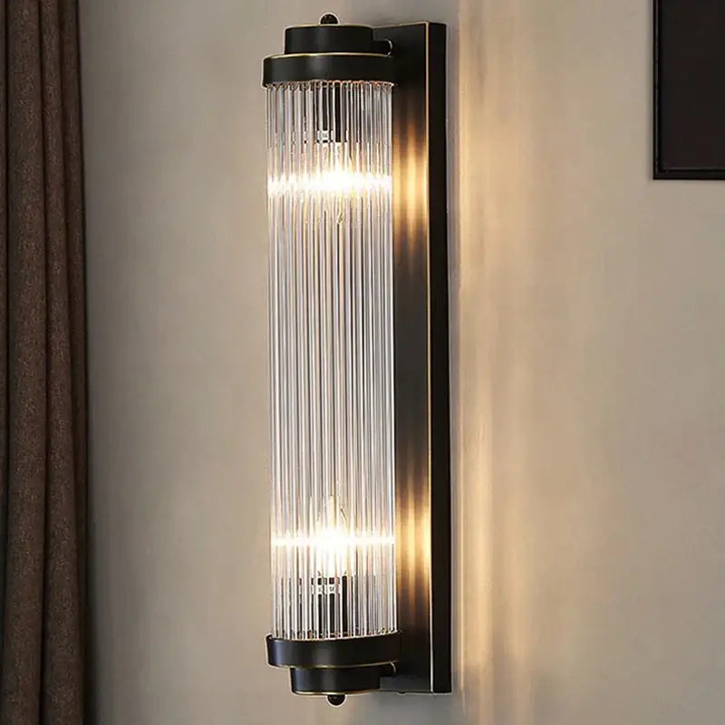 Modern black metal wall lamp with vertical glass rods emitting warm light decorbites crystal led wall sconce for bedroom