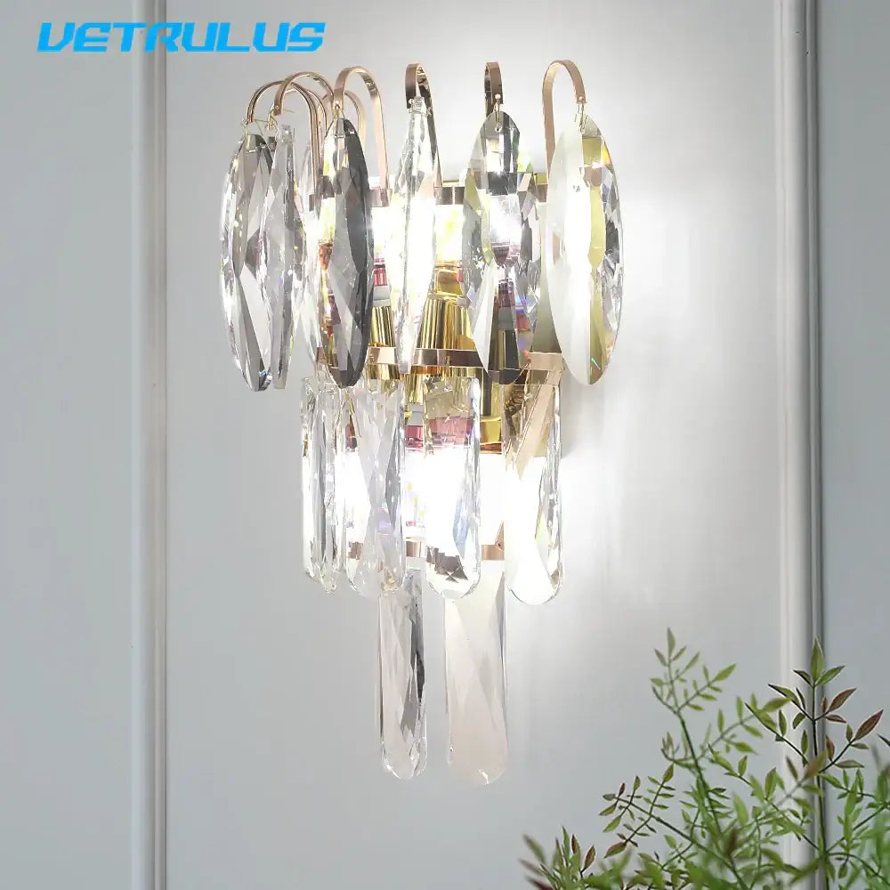 Modern gold crystal led wall lamp with decorbites crystal led featuring a gold metal frame and clear faceted droplets