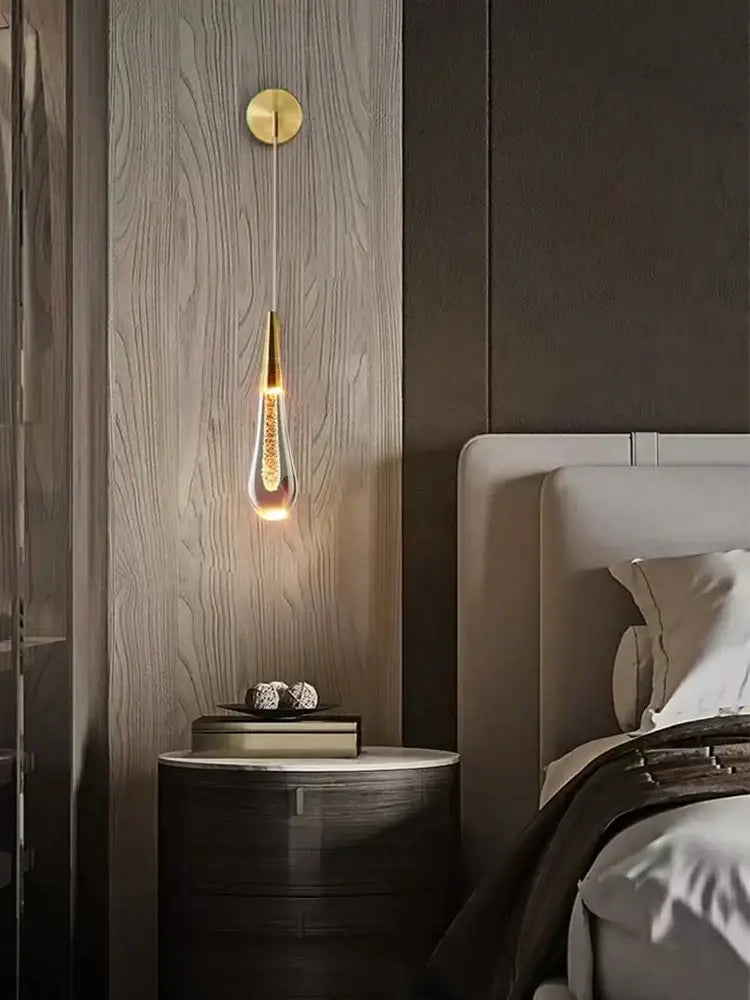 Modern gold crystal led wall lamp featuring a teardrop-shaped glass body with sparkling details for bedroom decorbites crystal led wall