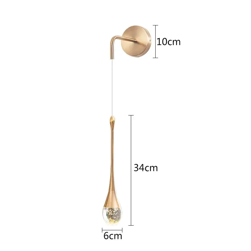 A modern gold crystal led wall lamp bedroom teardrop sconce with a sleek glass pendant and brass mounting plate decorbites crystal led