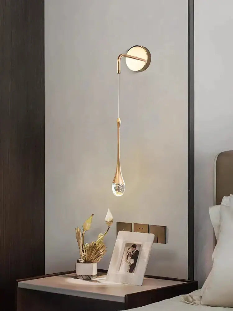 Modern gold crystal led wall lamp featuring a teardrop glass pendant and curved metallic arm for elegant decorbites crystal led decor