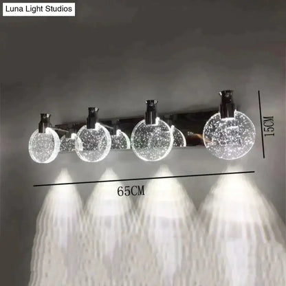 Modern gold crystal led wall lamp featuring three simple crystal led globes with sleek chrome accents and illumination