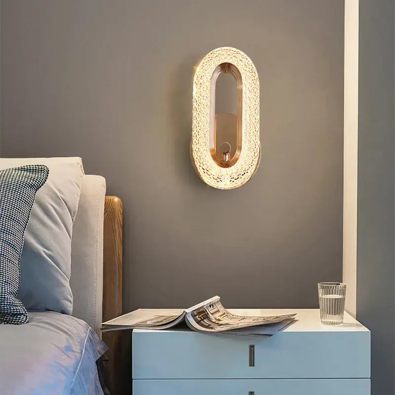 Modern gold crystal led wall lamp with an oval gold-toned frame and lace-like glass mosaic design for living room