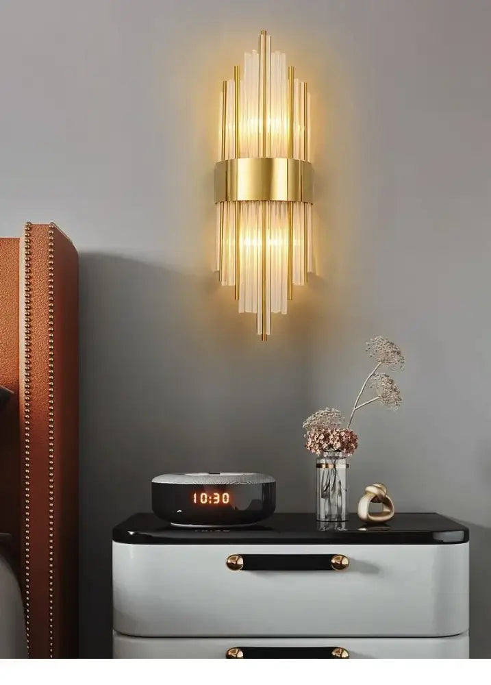 Modern gold crystal led wall light with vertical glass rods and central metallic band for elegant decorbites crystal led decor