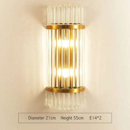 Modern gold led wall sconce with vertical crystal glass rods and a warm glowing light for bedroom use