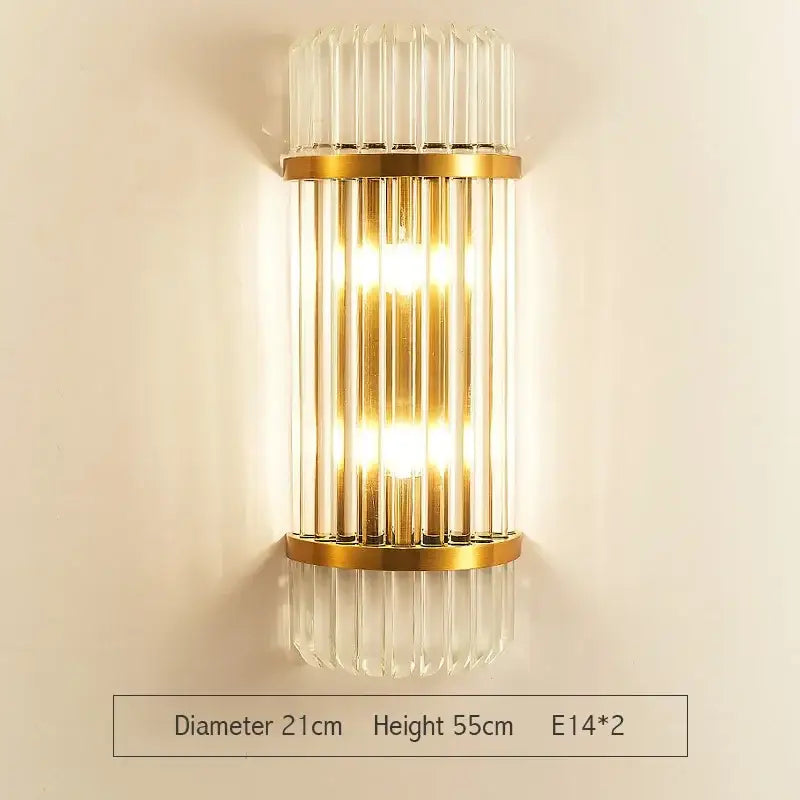 Modern gold led wall sconce with vertical crystal glass rods and a warm glowing light for bedroom use