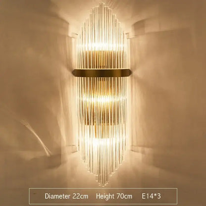 Modern gold crystal led wall sconce featuring vertical glass rods and metal accents for bedroom lighting