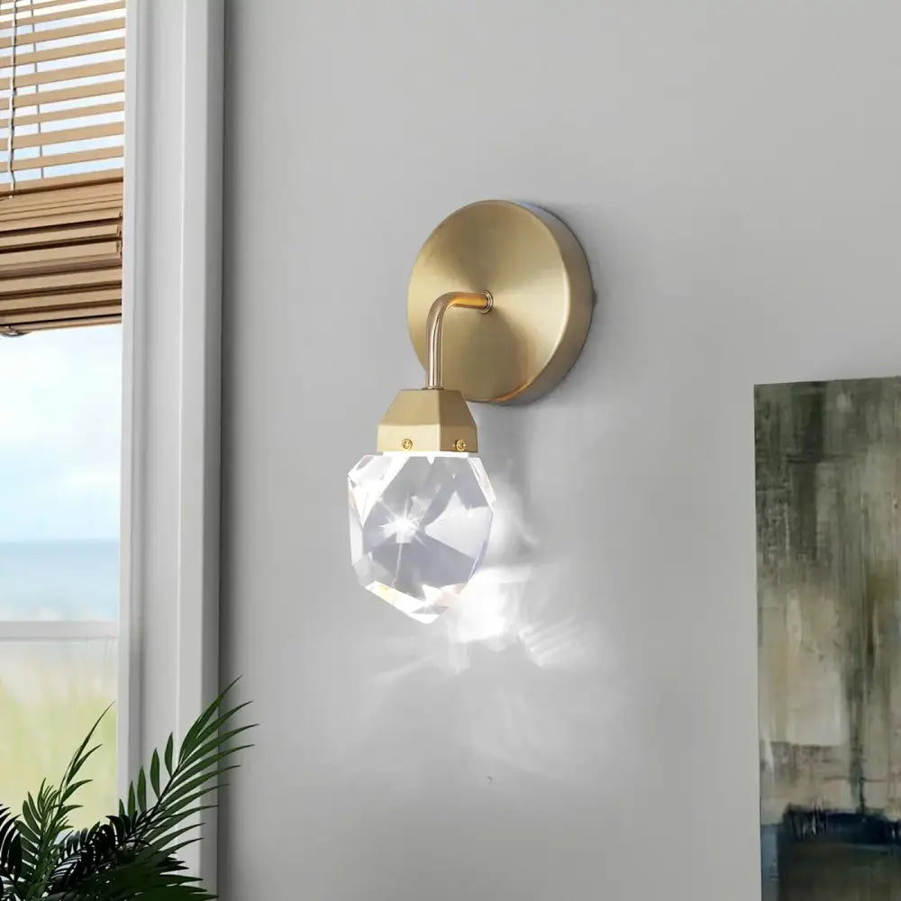 A modern gold crystal led wall sconce with a clear faceted crystal pendant for luxury bedroom decorbites crystal led lighting