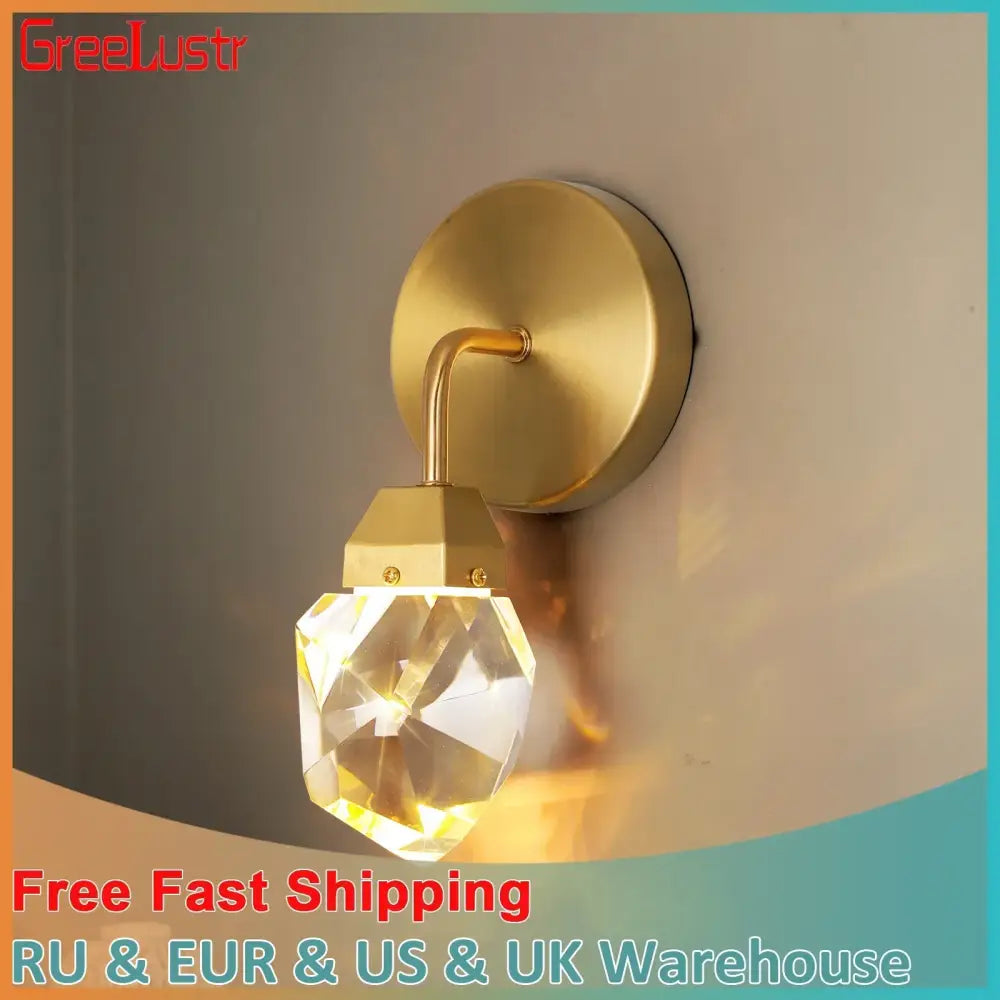 Modern gold crystal led wall sconce with faceted crystal globe for luxury bedroom decor by Decorbites crystal led