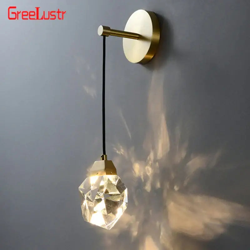 Modern gold crystal led wall sconce with faceted globe pendant and black cord for luxury bedroom decorbites crystal led lighting
