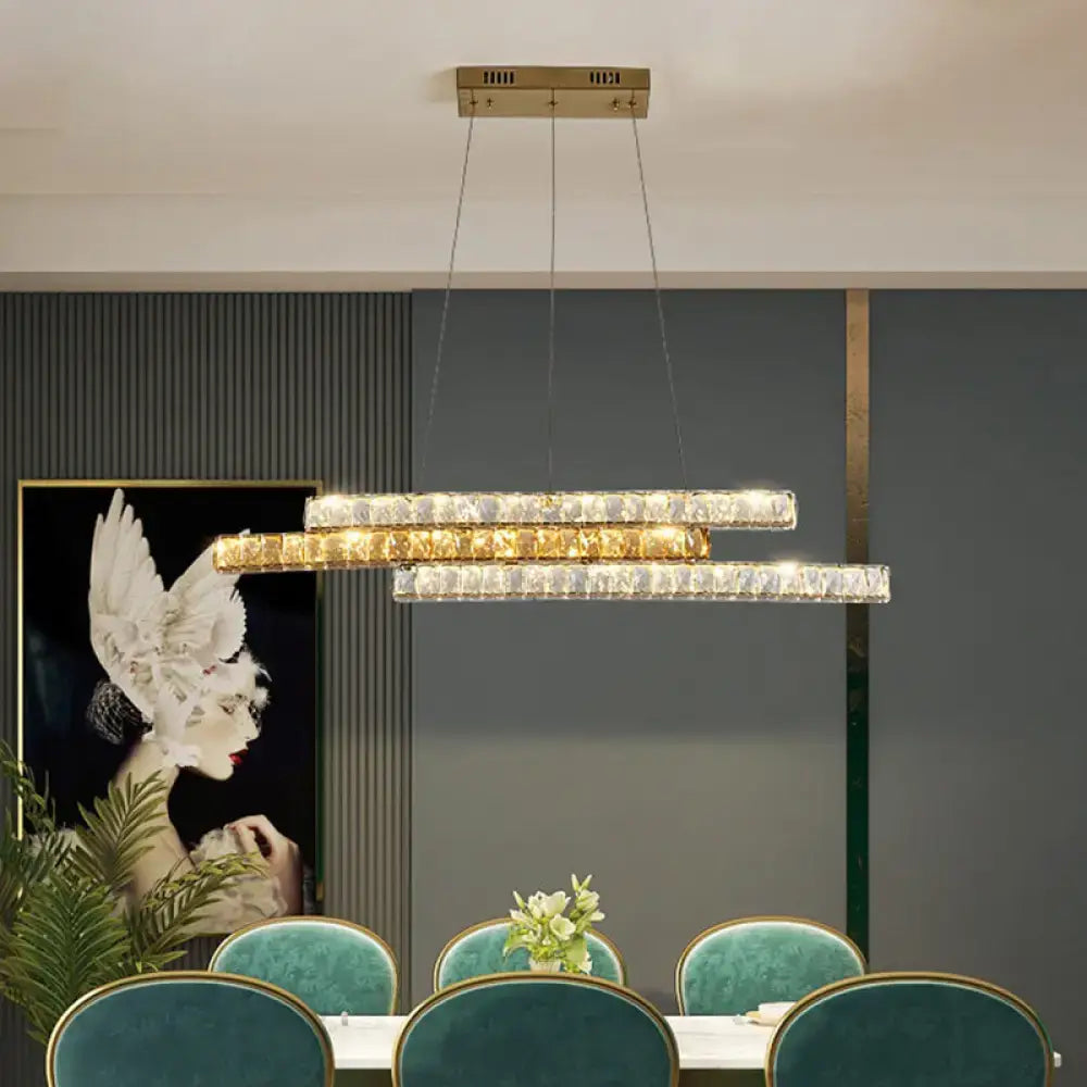 A modern decorbites gold linear island light with layered crystal bars and gold-toned ceiling mount and led design