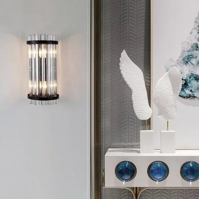 Modern gold crystal luxury wall lamp with vertical crystal tubes and black metal frame for elegant bedroom decorbites crystal luxury wall